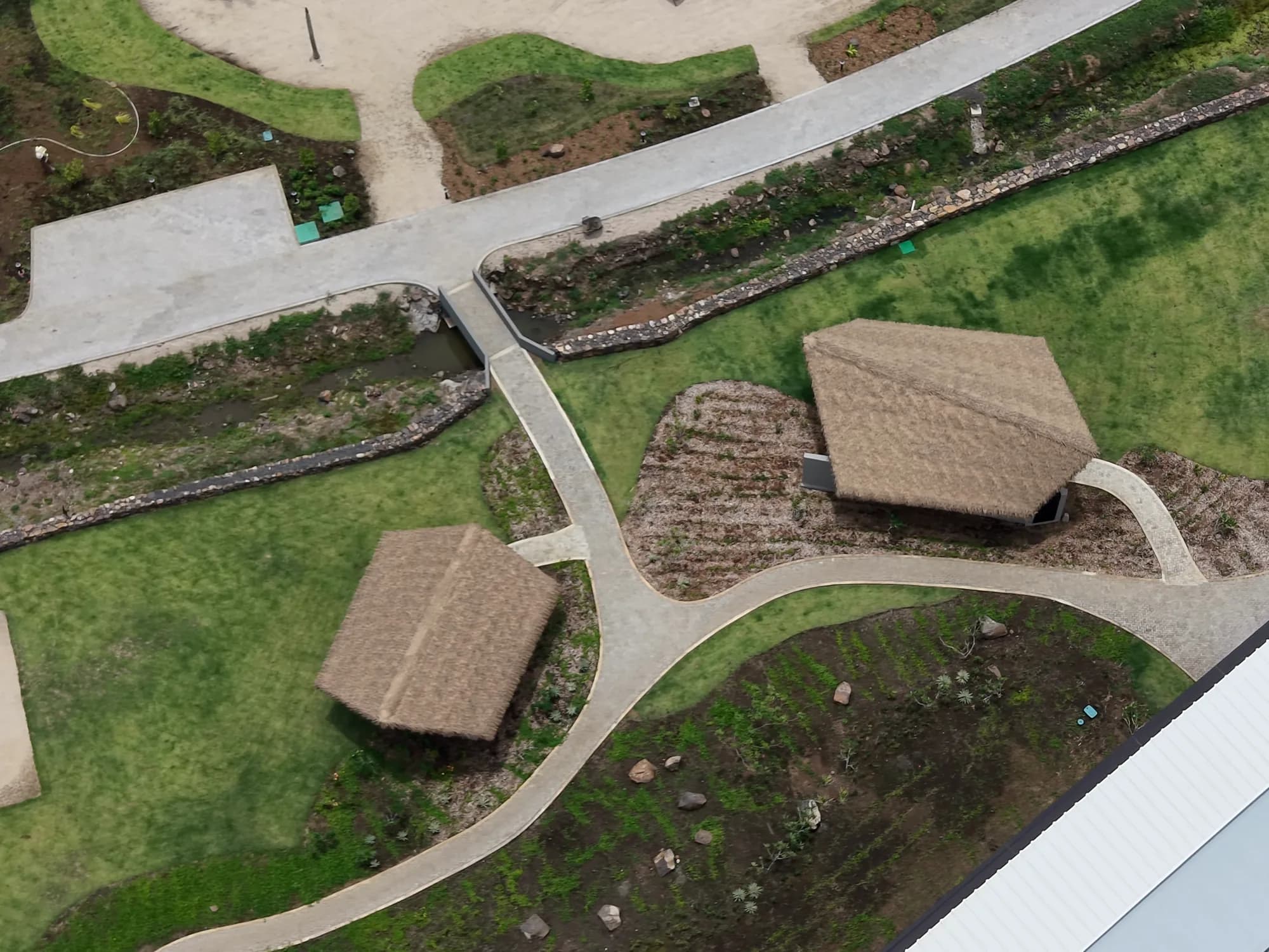 Top-down view of two palapas and their paths